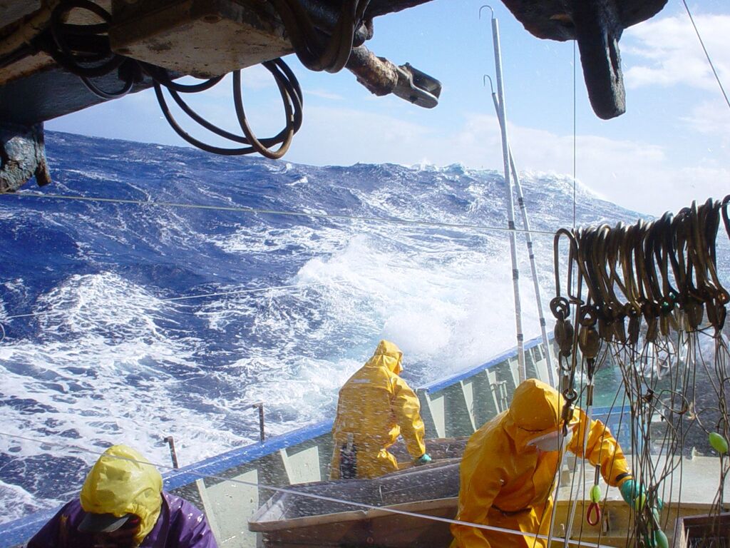Crew working on deck in rough seas